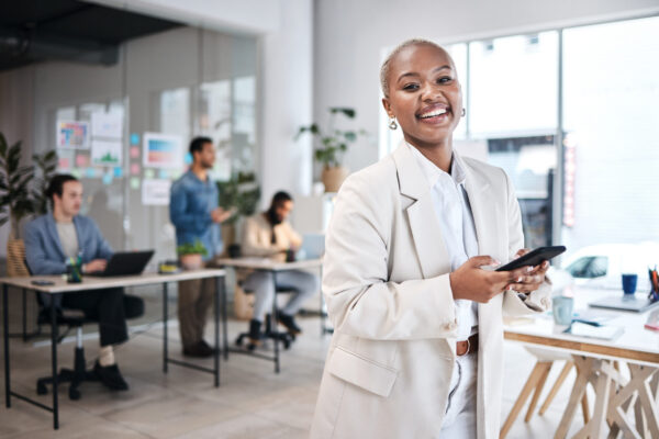 Phone, accountant and portrait of black woman, happy and smile in company, business workplace or coworking. Smartphone, face of auditor and excited African professional, entrepreneur or employee